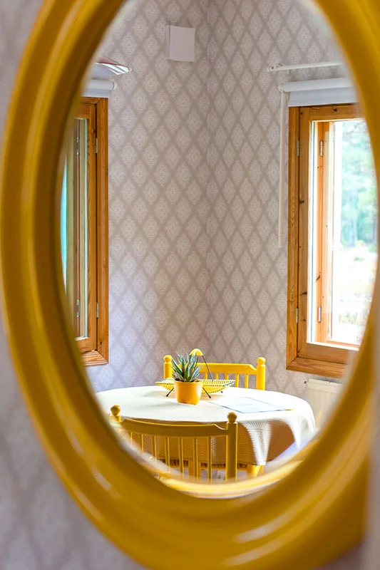 Mirror reflecting a yellow room at Solvillan